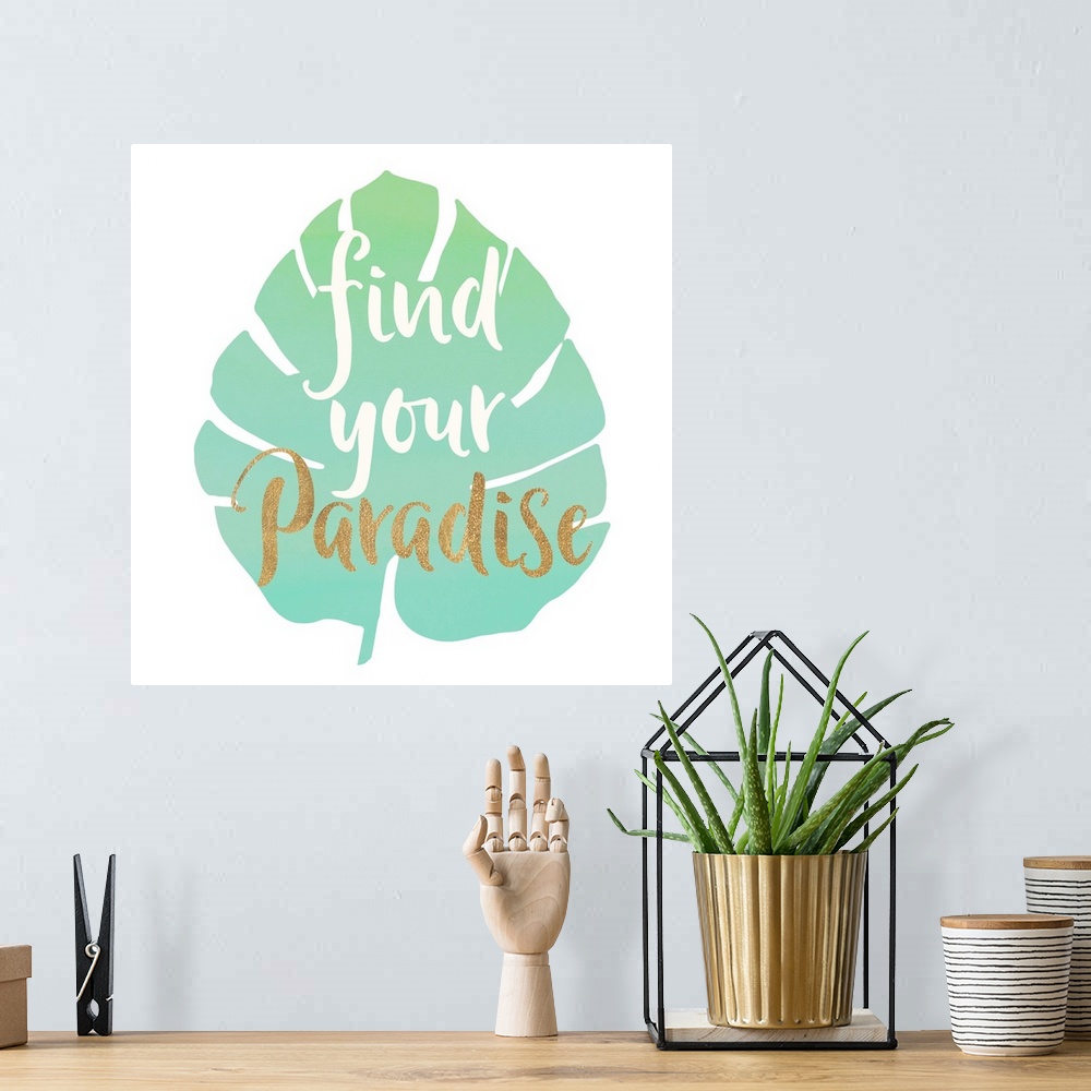 A bohemian room featuring White and gold handlettered text over a green tropical leaf.