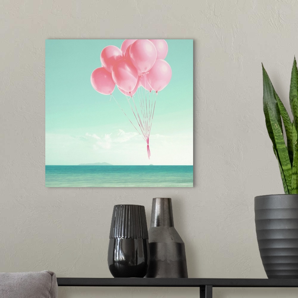 A modern room featuring Pink balloons floating over the ocean on a square background.