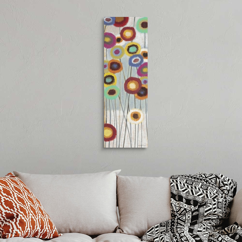 A bohemian room featuring Contemporary abstract painting of colorful flowers on long stems.