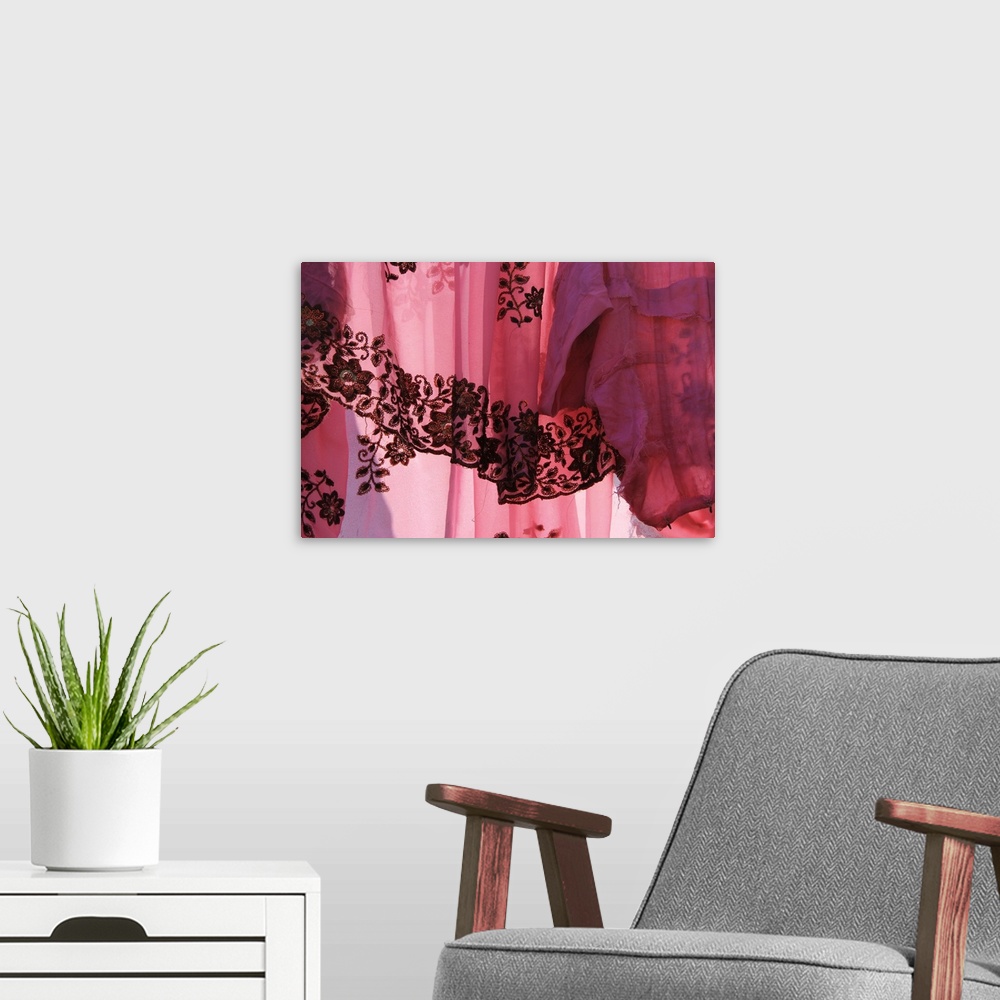 A modern room featuring Photograph of a sheer vibrant pink fabric.