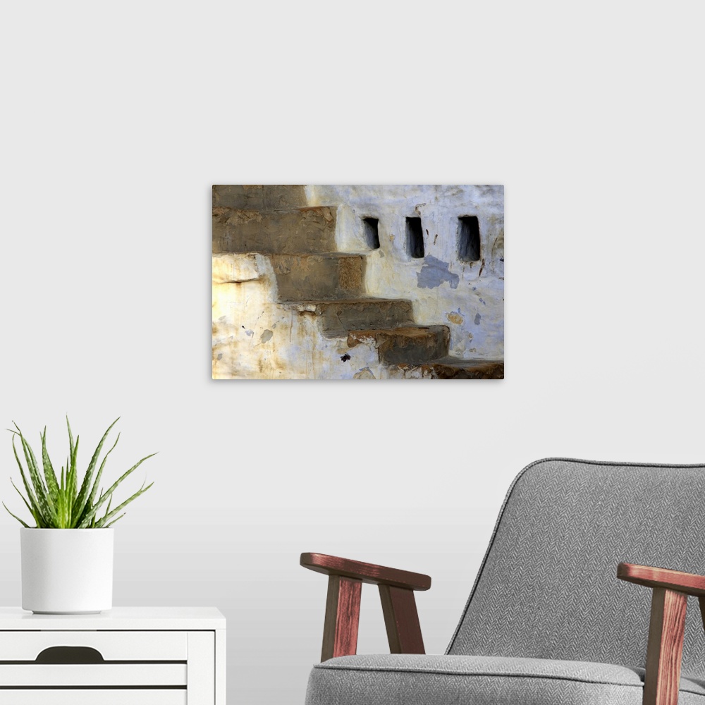 A modern room featuring Photograph of a weathered stone wall with cracked steps.