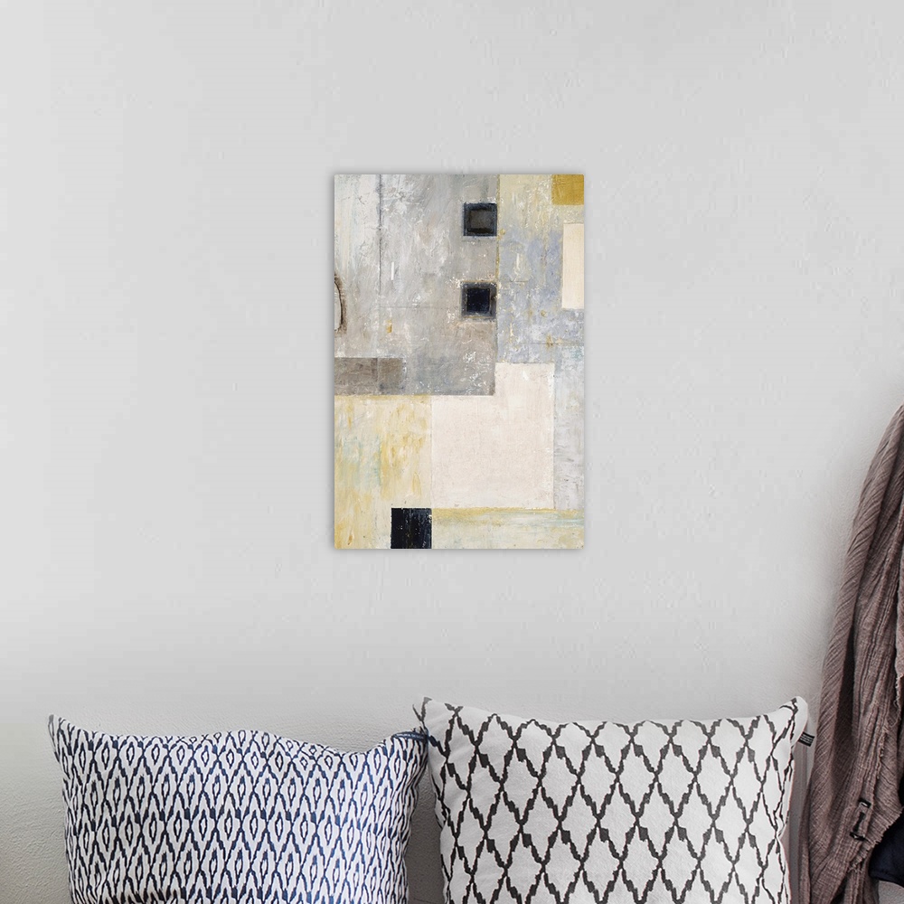 A bohemian room featuring Abstract geometric artwork in grey tones with black squares.