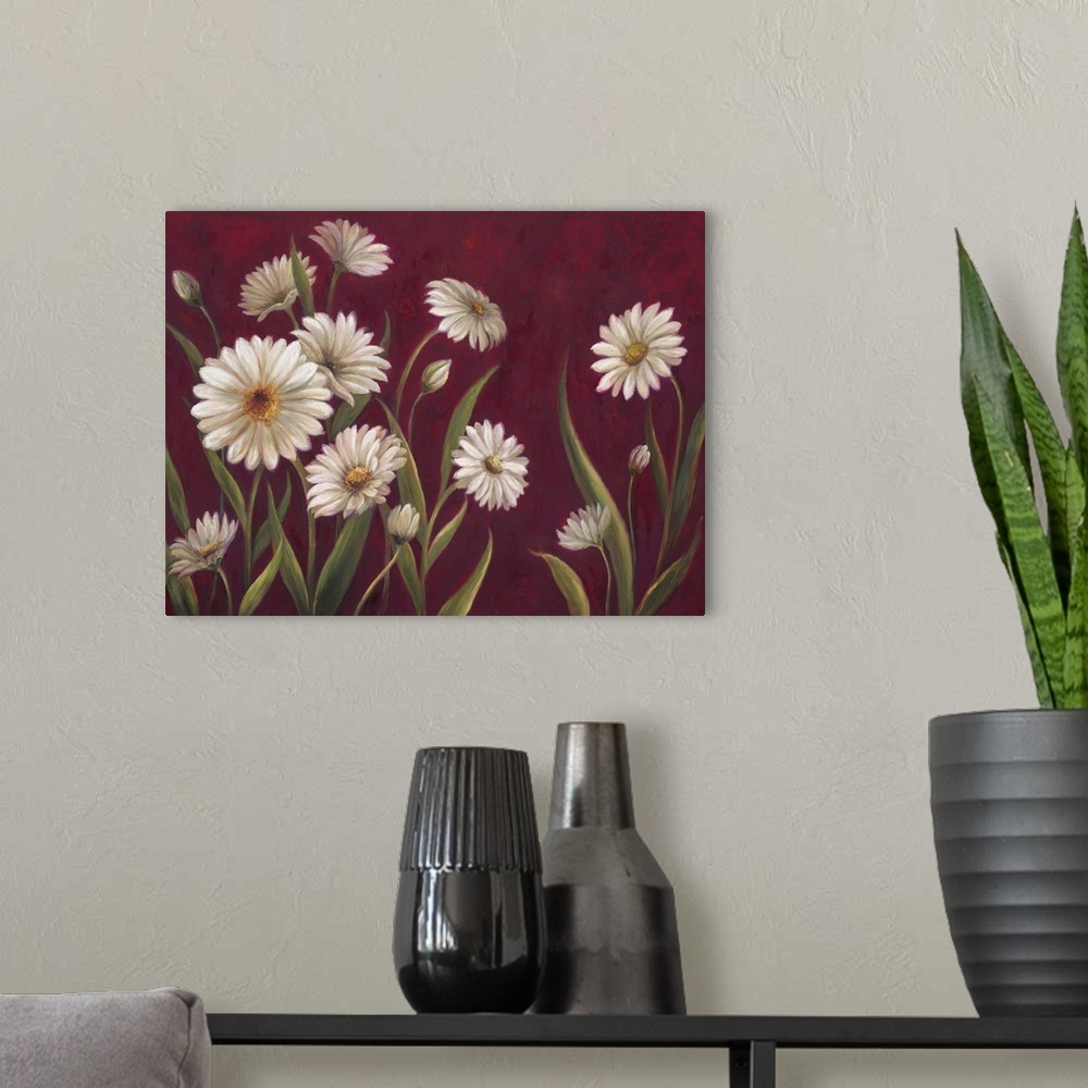 A modern room featuring Home decor artwork of white daisies against a deep red background.