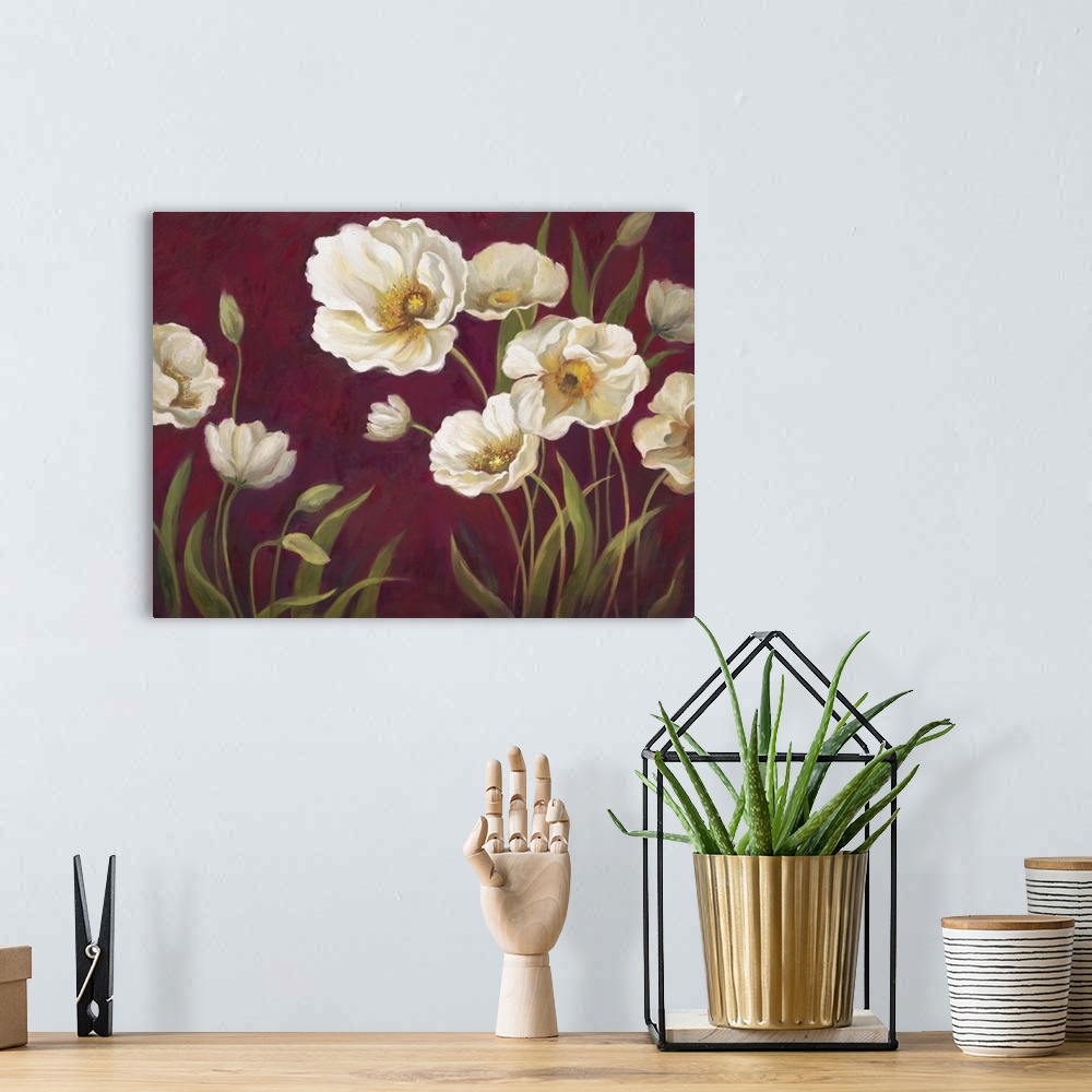 A bohemian room featuring Home decor artwork of white poppies against a deep red background.