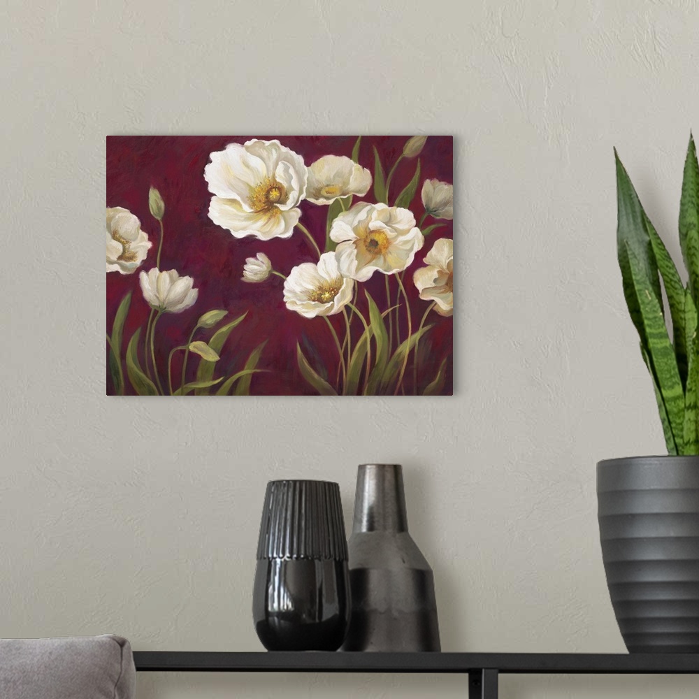 A modern room featuring Home decor artwork of white poppies against a deep red background.