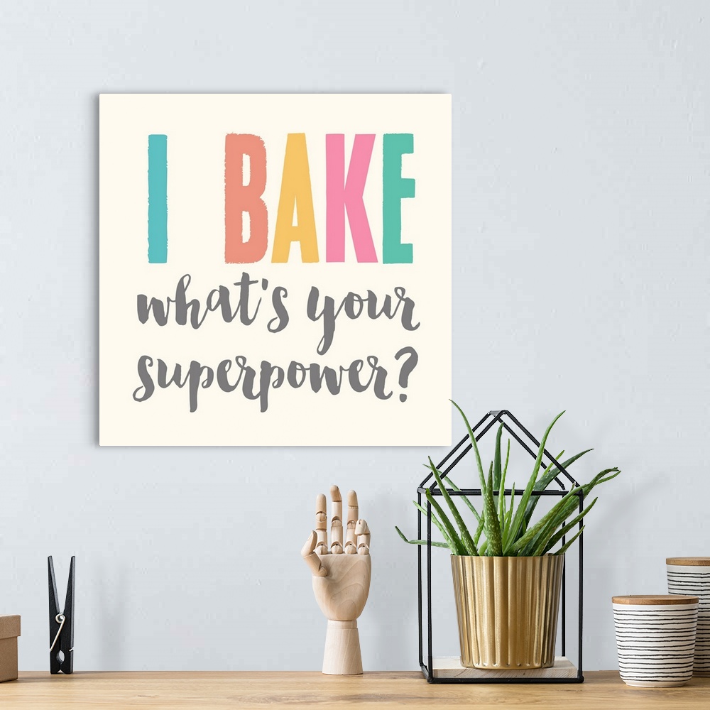 A bohemian room featuring Humorous typography artwork reading "I bake, what's your superpower?" in pastel text on off-white.
