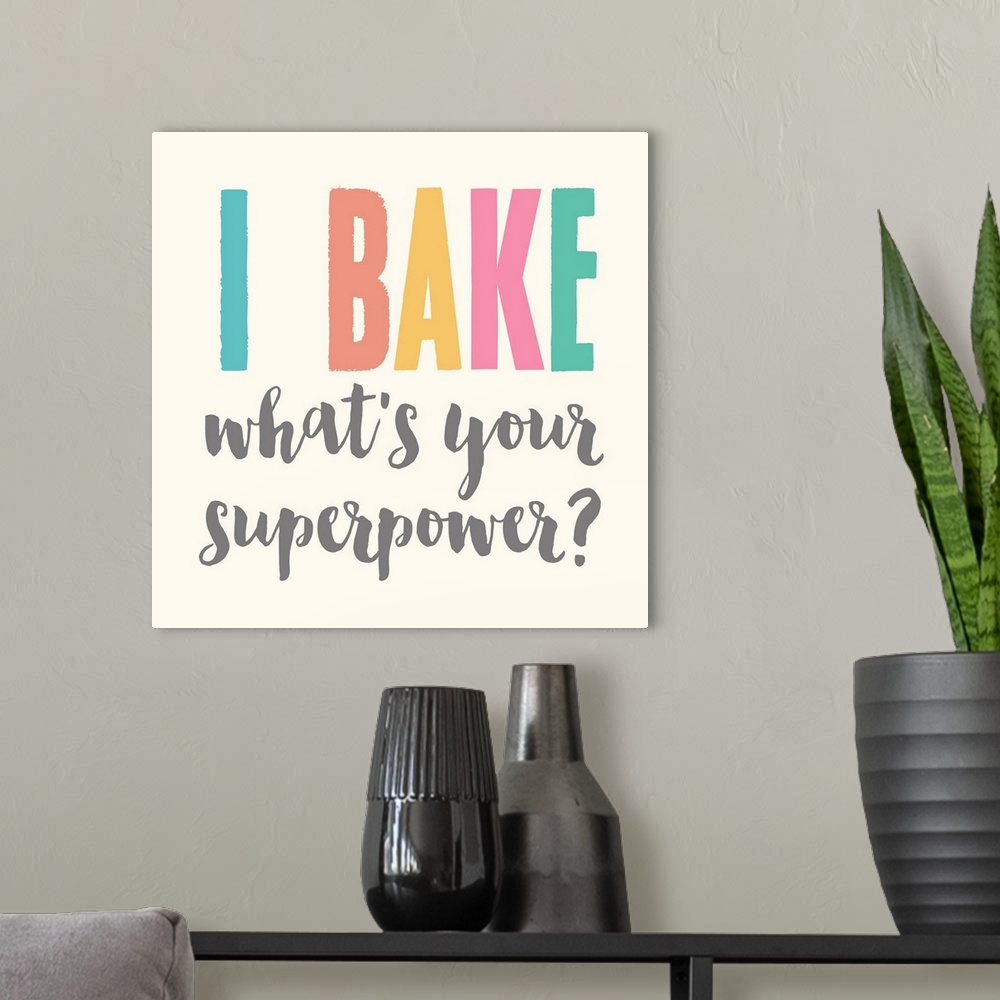 A modern room featuring Humorous typography artwork reading "I bake, what's your superpower?" in pastel text on off-white.