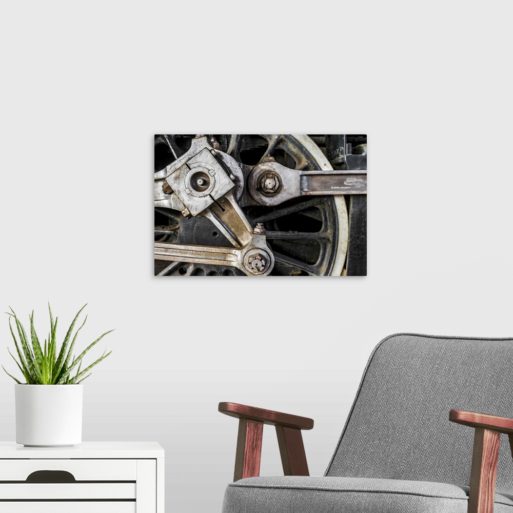 A modern room featuring A close-up photograph of the wheel of a train.