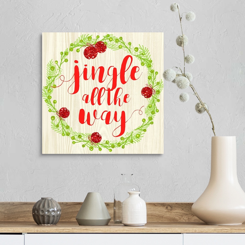 A farmhouse room featuring "Jingle All The Way" written in red inside of a Christmas wreath on a faux wood background.
