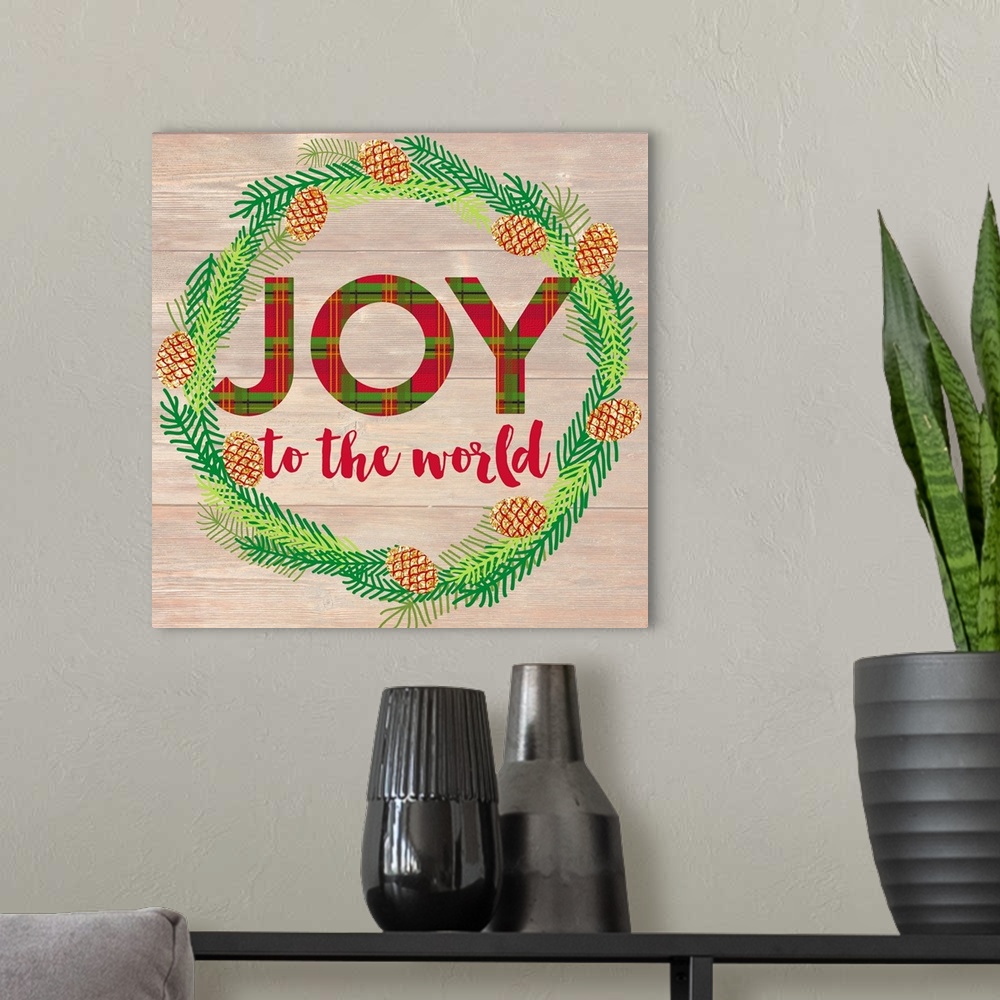 A modern room featuring "Joy To The World" written inside of a Winter wreath in blue, green, and gold hues on a faux wood...