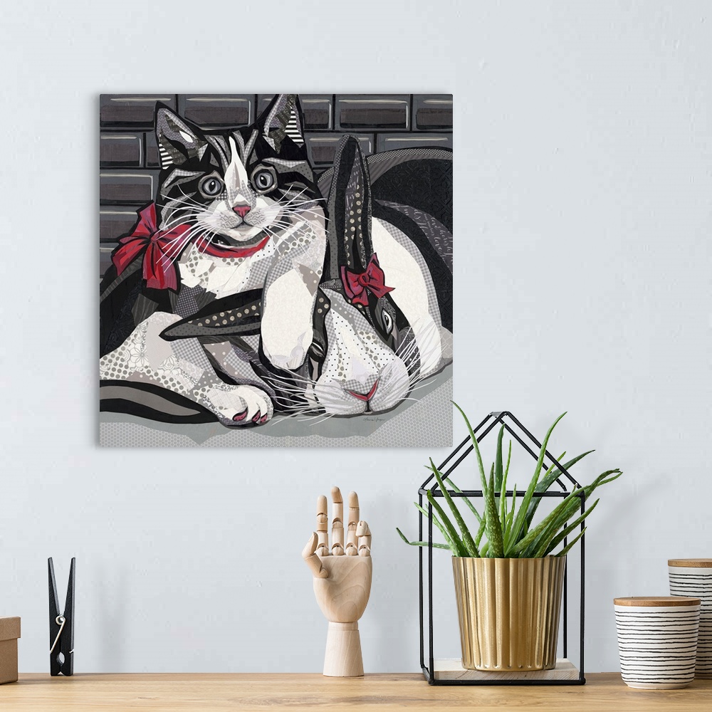 A bohemian room featuring Mixed media art in black and white of a cat and bunny snuggling with red bows on.