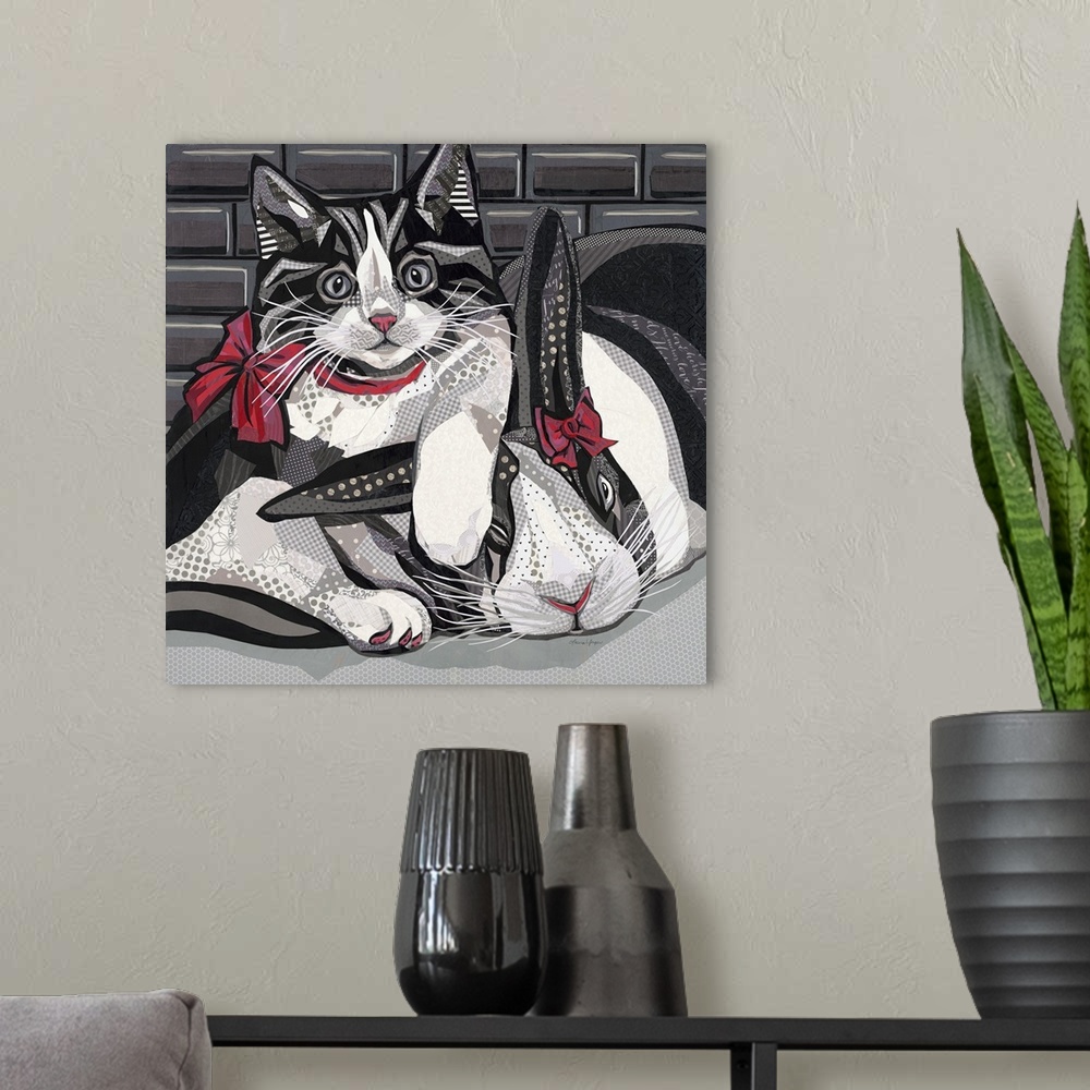 A modern room featuring Mixed media art in black and white of a cat and bunny snuggling with red bows on.