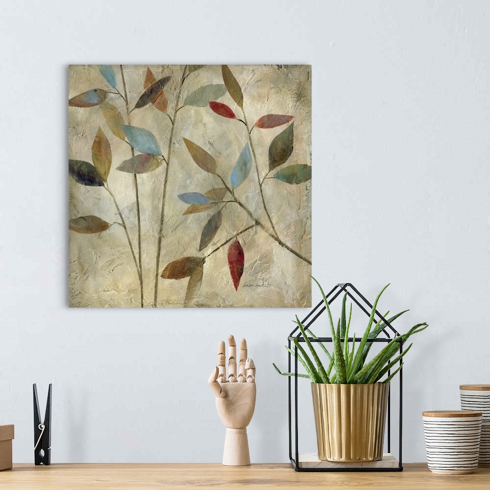 A bohemian room featuring Painting of thin branches with different colored leaves in muted colors.