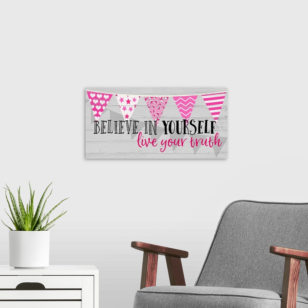 A modern room featuring "Believe in Yourself Lice Your Truth" written on a panel with pink decorative banners running hor...