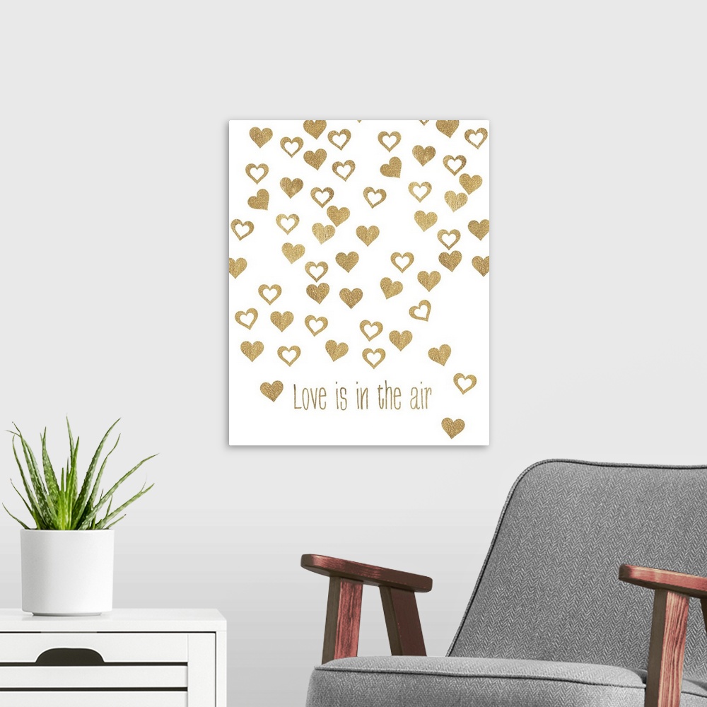 A modern room featuring Gold lettering and floating heart shapes against a white background.