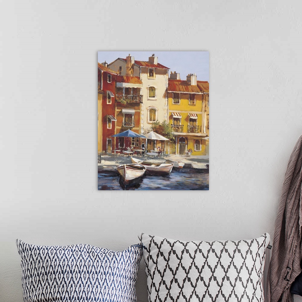 A bohemian room featuring Contemporary painting of city waterfront filled with boats.