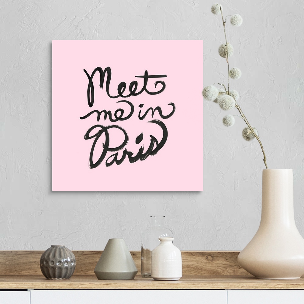 A farmhouse room featuring "Meet Me In Paris" hand lettered in black on a pastel pink background.