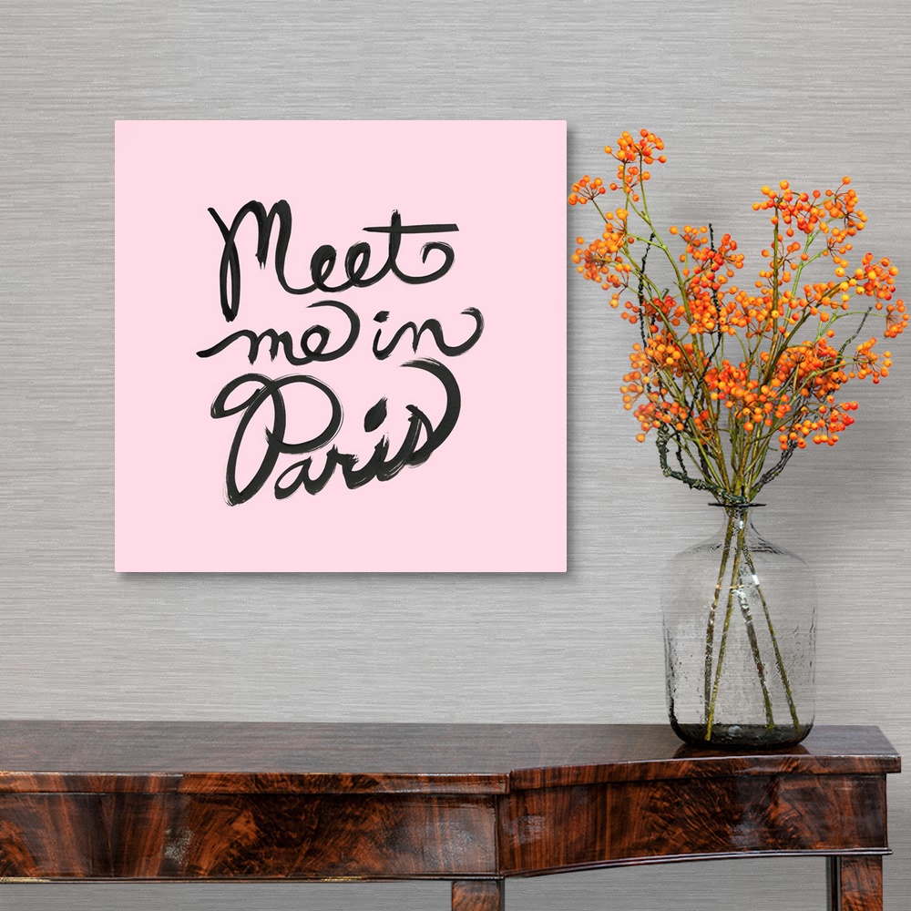 A traditional room featuring "Meet Me In Paris" hand lettered in black on a pastel pink background.