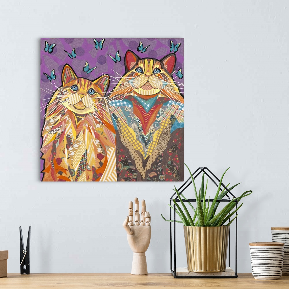 A bohemian room featuring Colorful collage artwork of two cats with long whiskers.