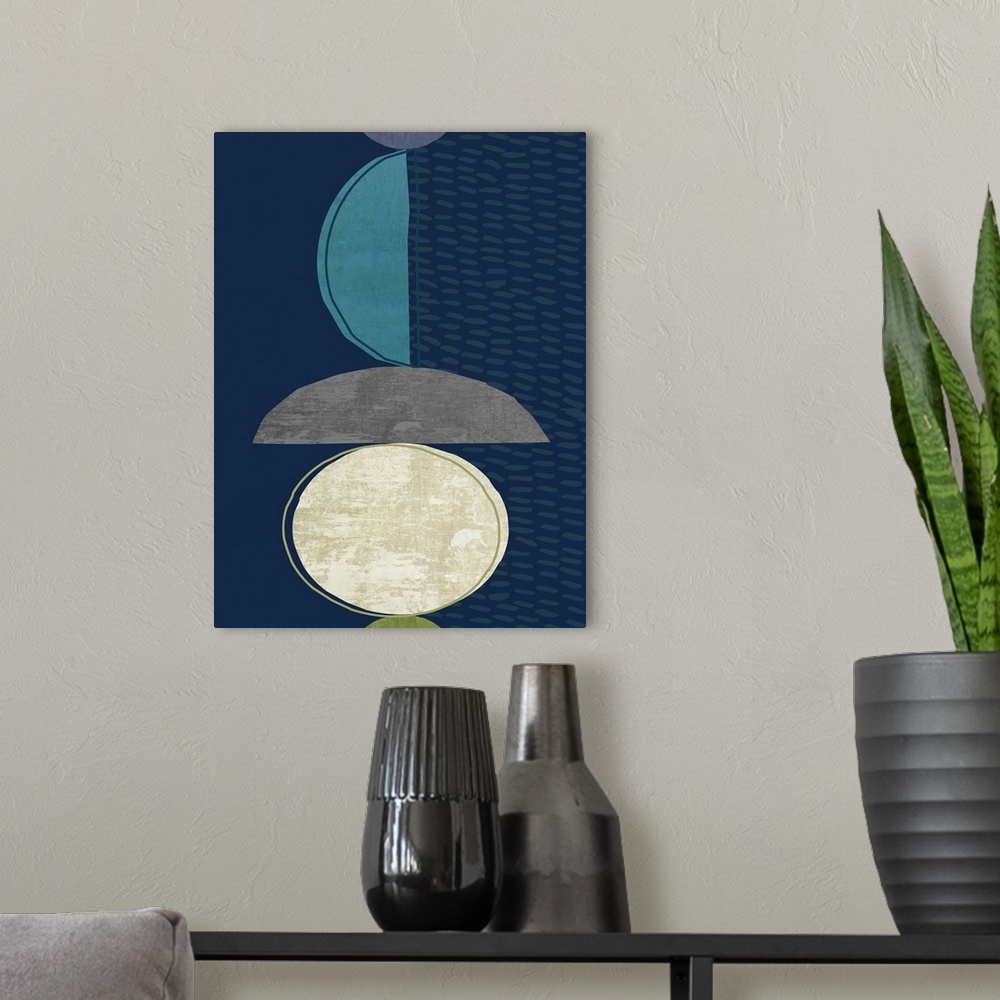 A modern room featuring Midcentury style abstract art of semi-circle shapes in blue, grey, and white on navy blue.