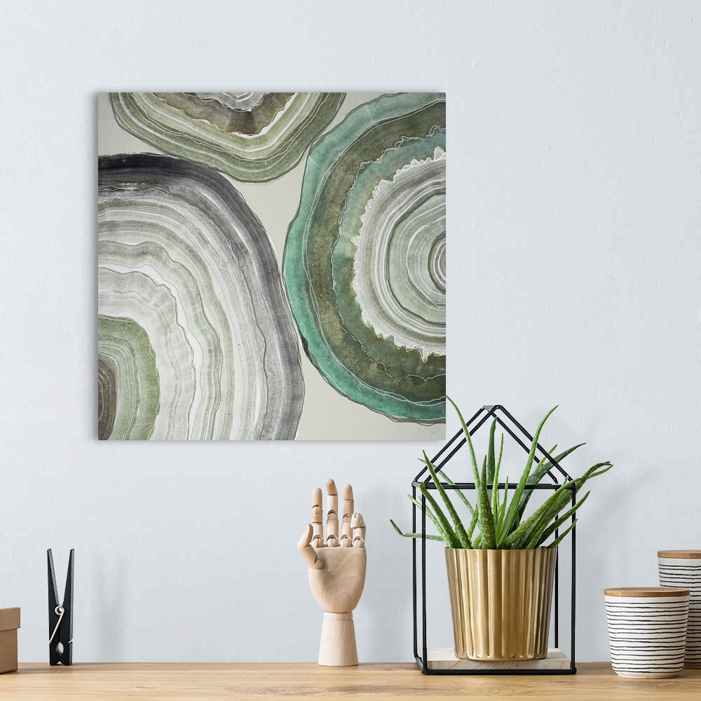 A bohemian room featuring Contemporary home decor artwork of pale colored geode cross sections against a gray background.