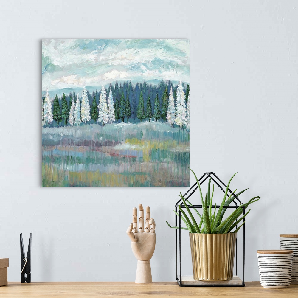 A bohemian room featuring Contemporary artwork of a field with an evergreen forest with white and green trees at the edge.