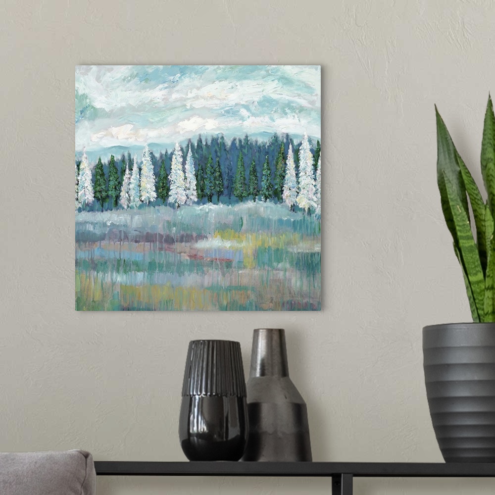 A modern room featuring Contemporary artwork of a field with an evergreen forest with white and green trees at the edge.
