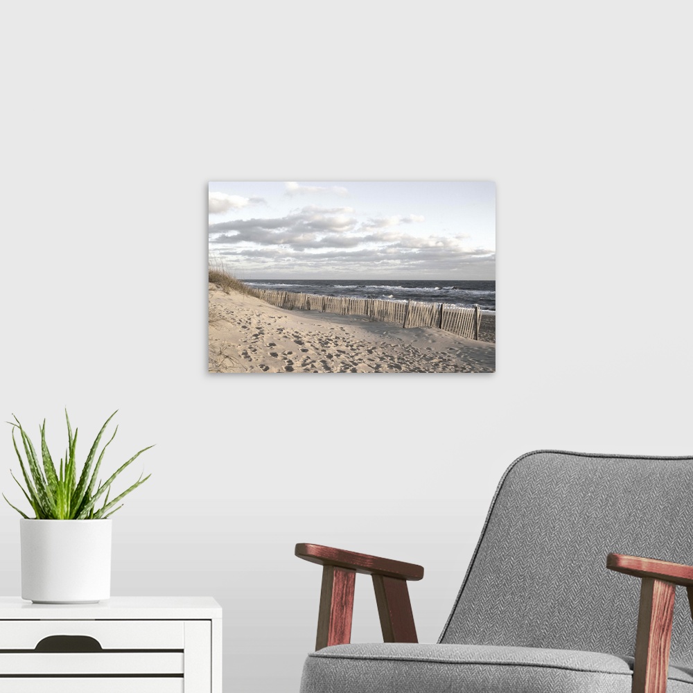 A modern room featuring Photograph of a sandy beach at sunset.