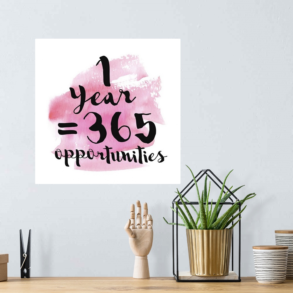 A bohemian room featuring Handlettered black text reading "1 Year = 365 Opportunities" over a pink watercolor wash.