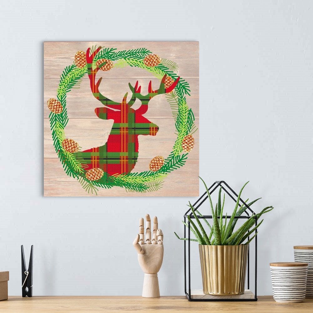 A bohemian room featuring Plaid silhouette of a deer inside of a Winter wreath in blue, green, and gold hues on a faux wood...