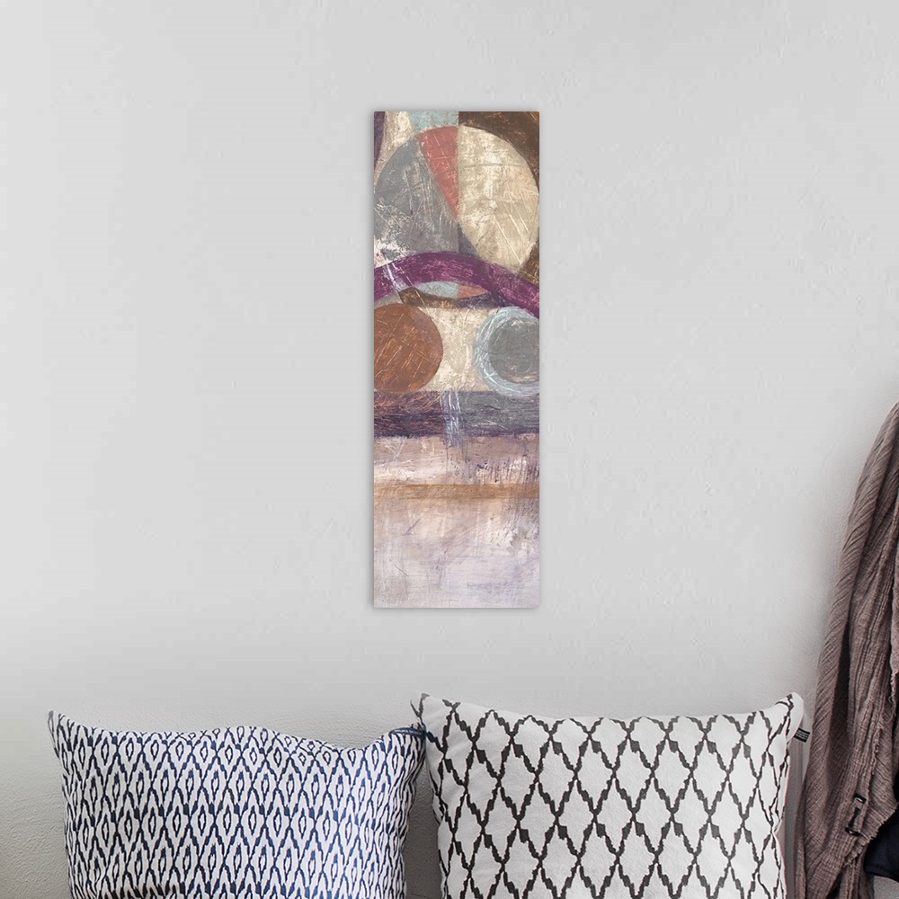 A bohemian room featuring Vertical abstract artwork with circular geometric shapes in browns and purples.