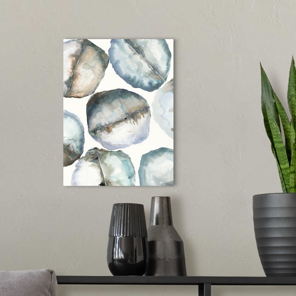 A modern room featuring Abstract artwork of organic round shapes in cool tones, resembling smooth rocks.