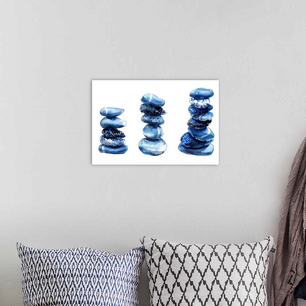 A bohemian room featuring Contemporary artwork of three stacks of round blue pebbles.