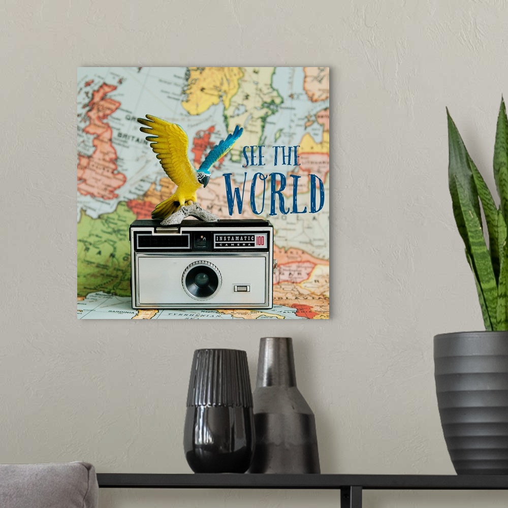 A modern room featuring A toy bird sitting on a vintage camera with a map backdrop.