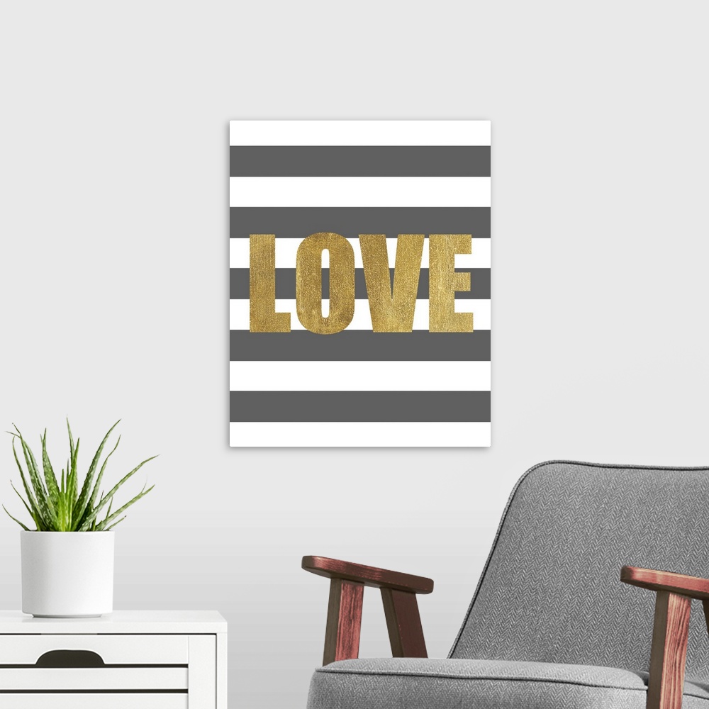 A modern room featuring The work Love in gold against a dark gray and white striped background.