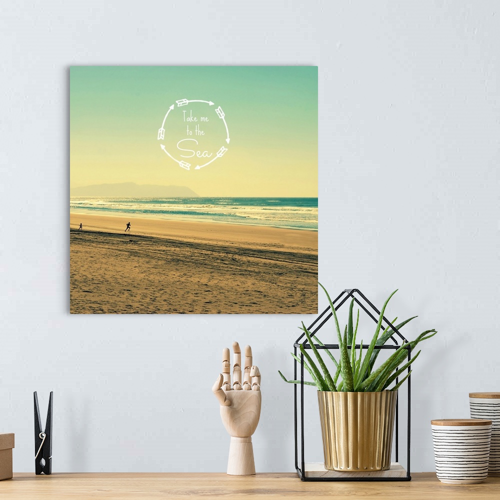 A bohemian room featuring "Take Me To The Sea" written inside a circle made with arrows on top of a square photograph of a ...