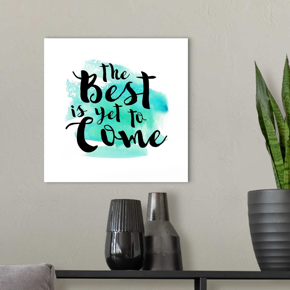 A modern room featuring Handlettered black text reading "The Best is yet to Come" over a teal watercolor wash.