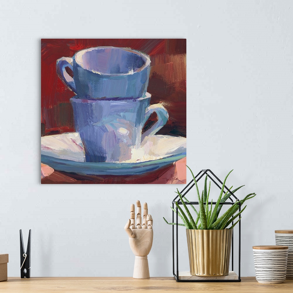 A bohemian room featuring Contemporary painting of teacups stacked on a teacup saucer against a red background.