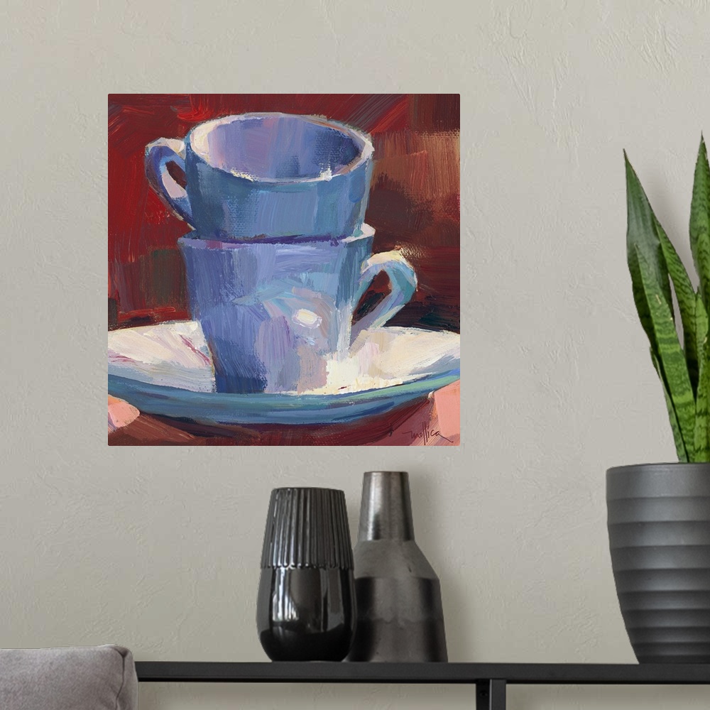 A modern room featuring Contemporary painting of teacups stacked on a teacup saucer against a red background.