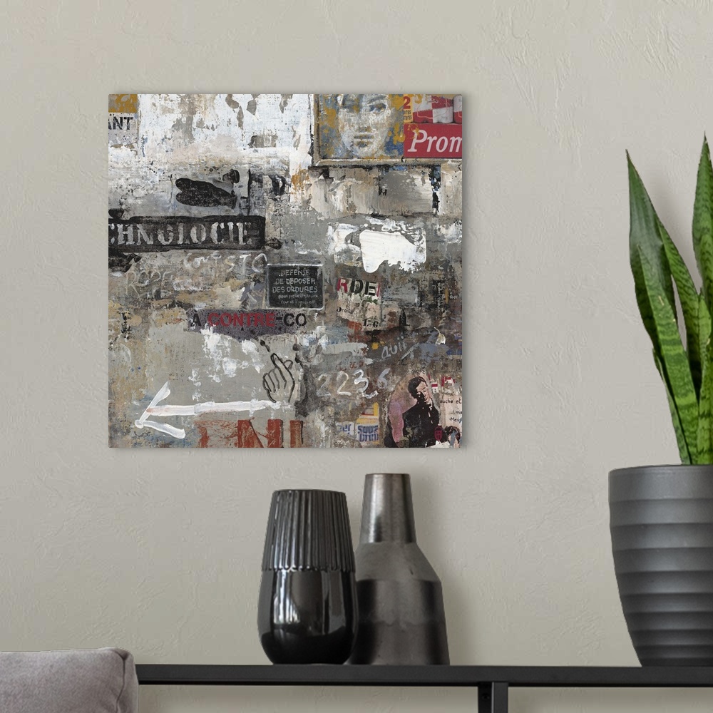 A modern room featuring Contemporary painting of graffiti and clippings arranged in a collage in moody grey tones.