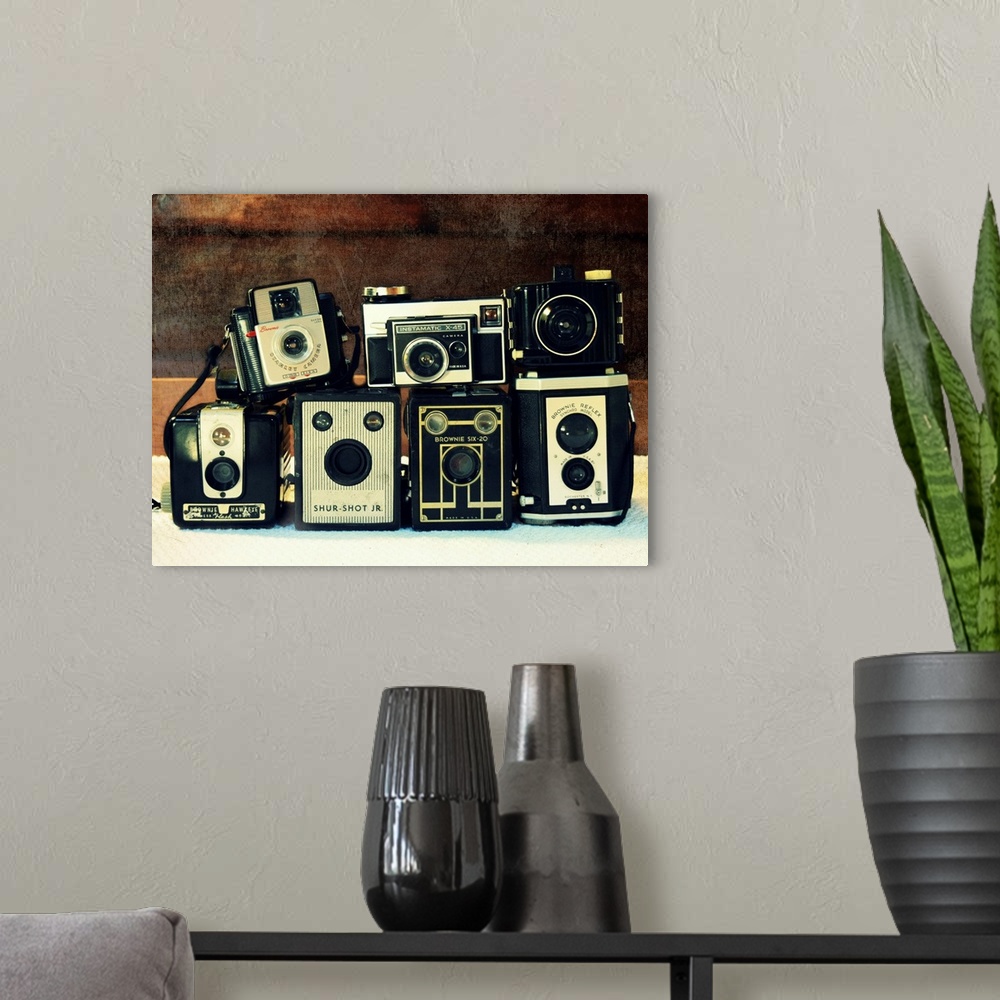 A modern room featuring Photograph of stacked vintage cameras.