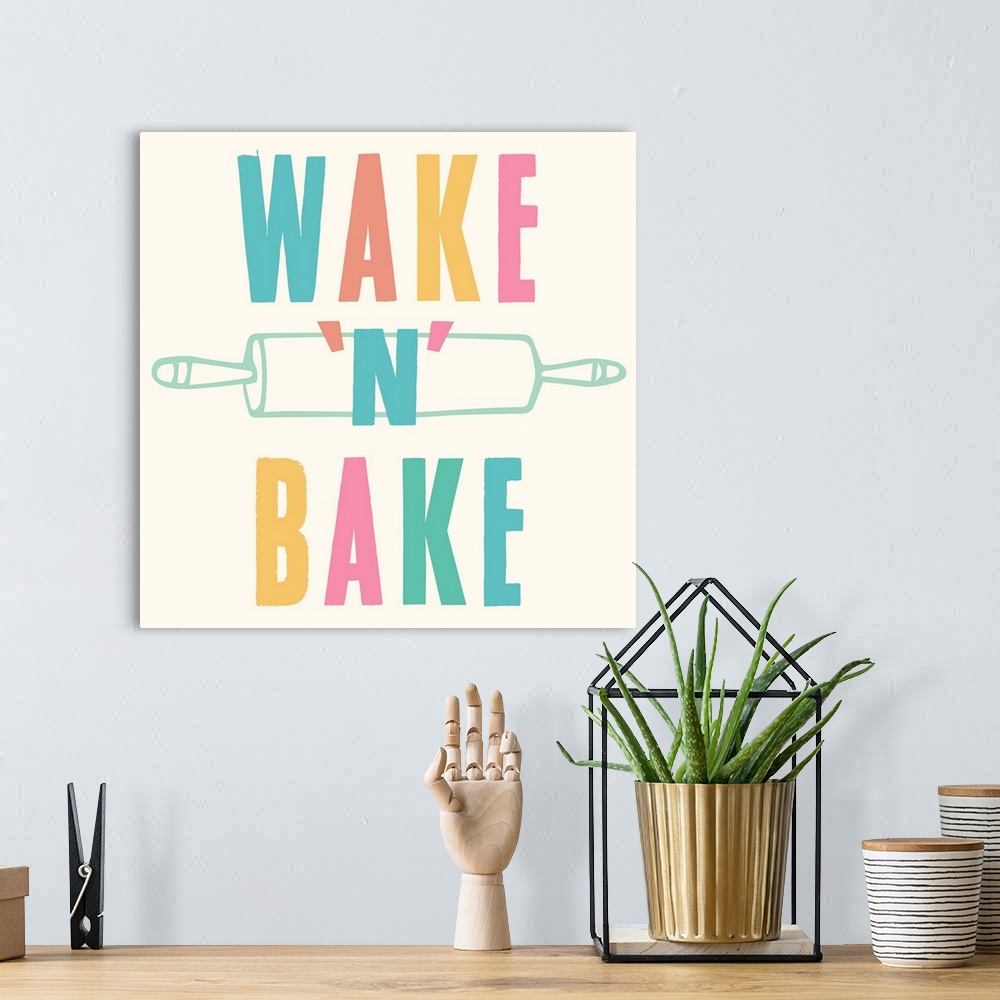 A bohemian room featuring Kitchen art with bold text in rainbow colors and a rolling pin.