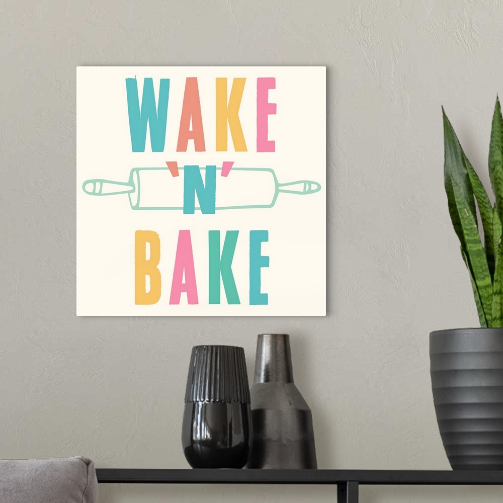 A modern room featuring Kitchen art with bold text in rainbow colors and a rolling pin.