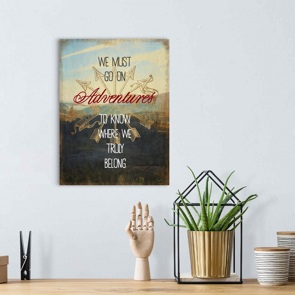 A bohemian room featuring Contemporary artwork with text over a photograph of a mountainous valley.