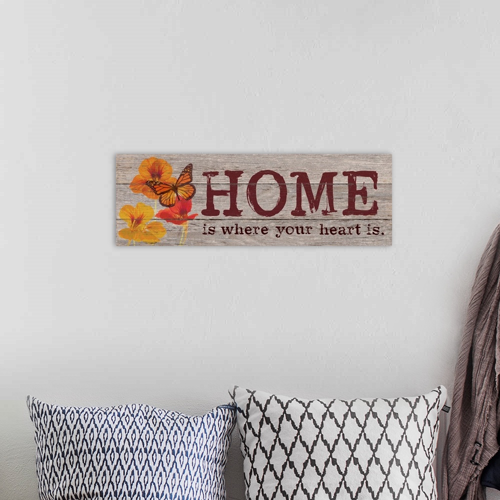 A bohemian room featuring Contemporary family art using flowers and typography on a rustic looking wooden surface.