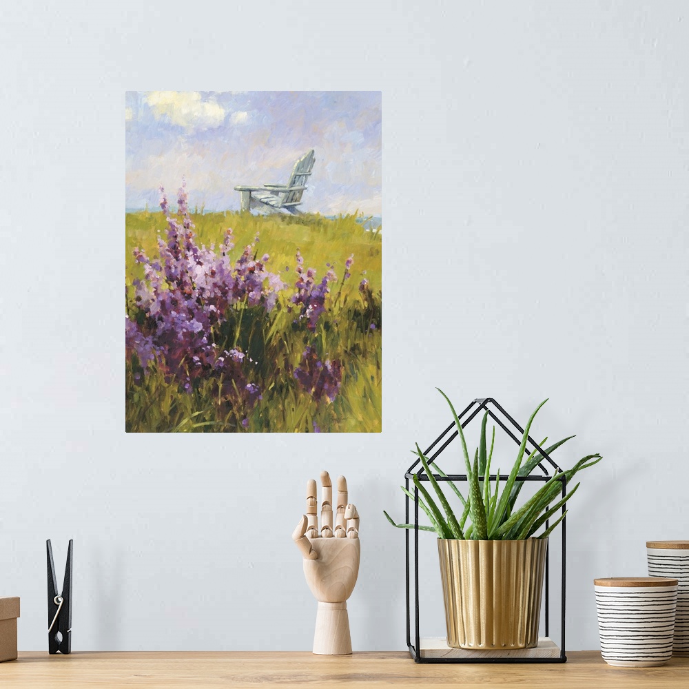 A bohemian room featuring Contemporary painting of a green field with purple wildflowers, with a white lounge chair in the ...
