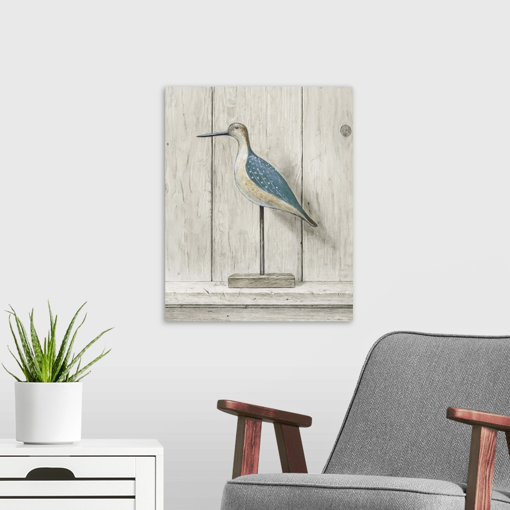 A modern room featuring Contemporary coastal themed artwork of a wooden bird statue against a washed wood background.