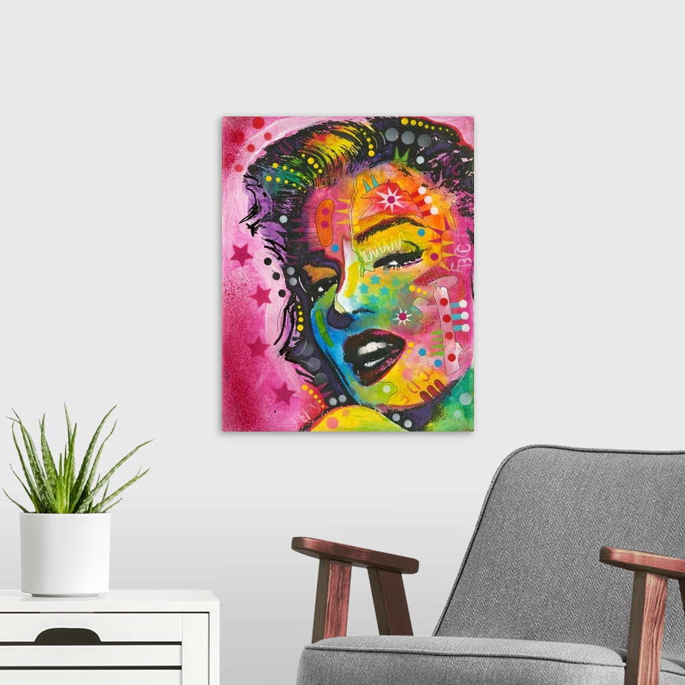A modern room featuring Pop art style painting of Marilyn Monroe with geometric abstract markings on a pink background wi...
