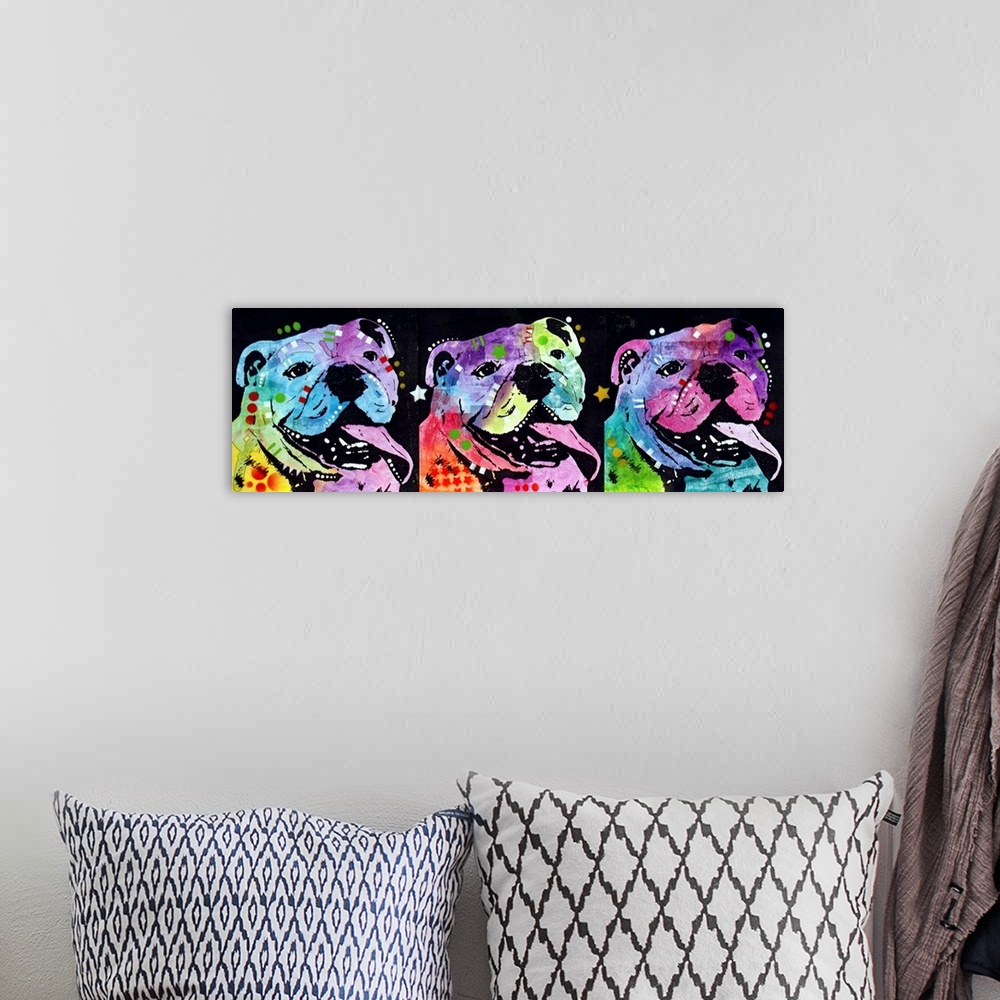 A bohemian room featuring Three colorful bulldogs lined up next to each other with their tongues hanging out on a black bac...