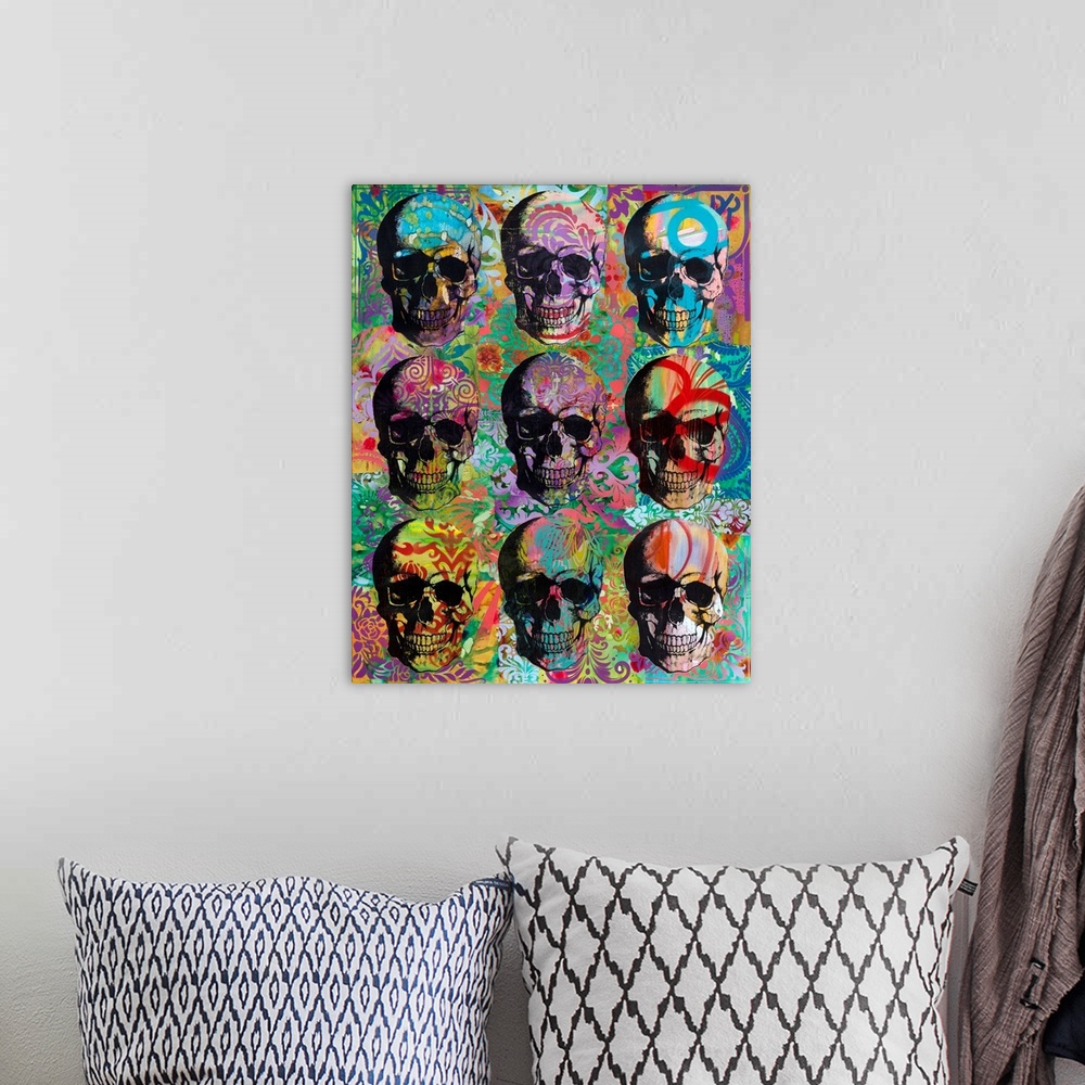 A bohemian room featuring 9 skulls in three rows with colorful abstract designs all over.